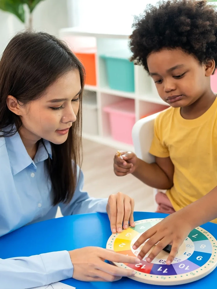 Therapist providing individualized Life ABA therapy to a young child with colorful blocks